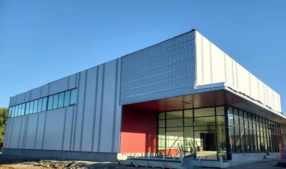New metal-panel commercial building with a glass storefront